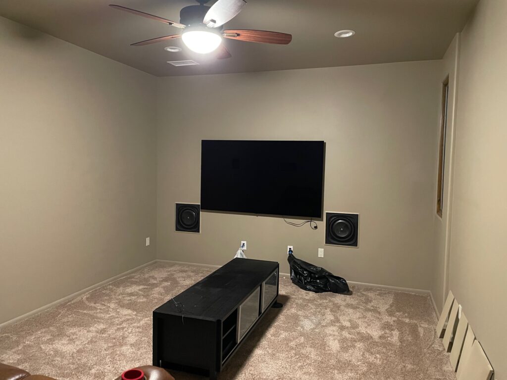 The room before upgrades. The JL Audio in-wall subwoofers can be seen on either side of the LG 77 video display